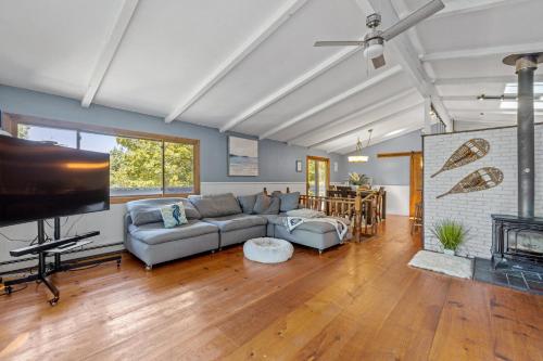 a living room with a couch and a tv at Dog friendly Family home at Lake Winnipesaukee & Gunstock in Gilford