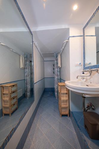 a bathroom with a sink and a mirror at Casa a Santa Maria di Leuca in Leuca