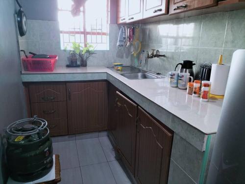 a kitchen with a sink and a counter top at Arunga's Homely Kakamega Stay in Kakamega