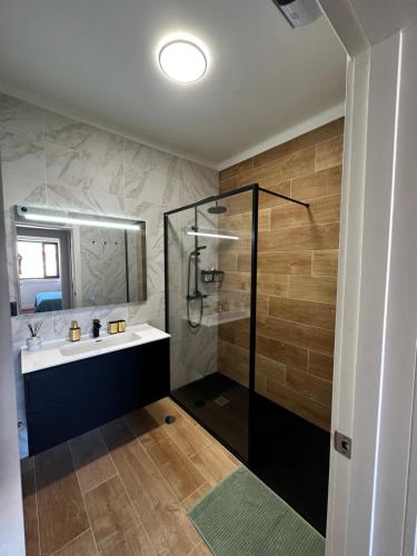 a bathroom with a sink and a shower at Ponte Velha in Peniche