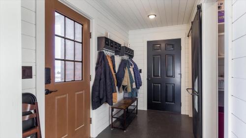 a hallway with a door and a coat rack at Targhee Shadows - Tetons Yellowstone hot tub in Tetonia