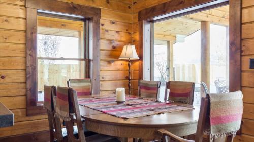 a wooden dining room with a table and chairs at Targhee Shadows - Tetons Yellowstone hot tub in Tetonia