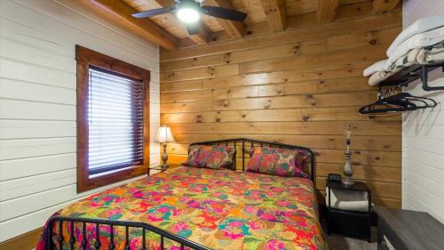 a bedroom with a bed in a room with wooden walls at Targhee Shadows - Tetons Yellowstone hot tub in Tetonia