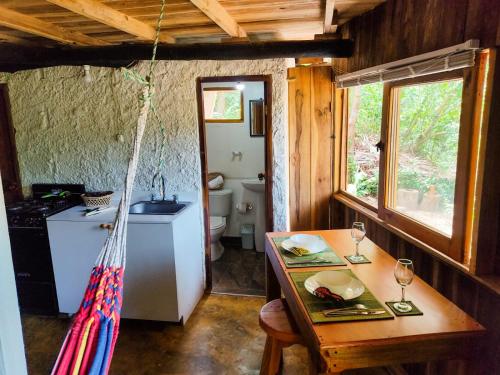 a room with a table and a sink and a toilet at Makuruma Chalet in Palomino