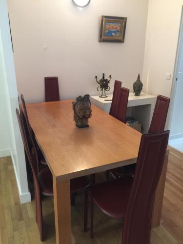 a dining room table with chairs and a wooden table at Private bedrooms near Eiffel Tower in Paris
