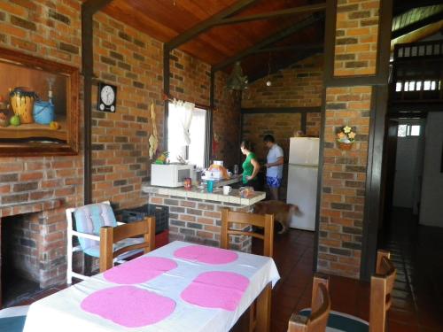 a kitchen with a table and a counter with a refrigerator at Villa Santa Maria in Santa María del Oro