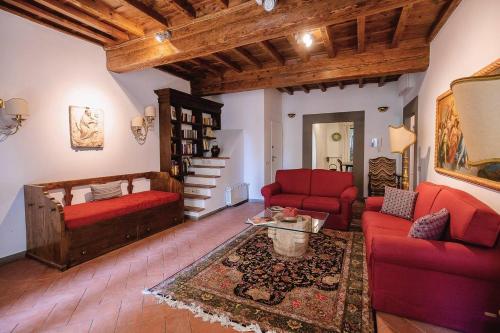 a living room with red couches and a table at Acacia Firenze - Adelfa in Florence