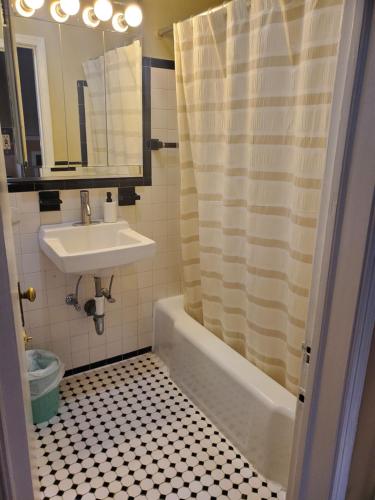 a bathroom with a sink and a toilet and a shower at The Orange House in Washington, D.C.