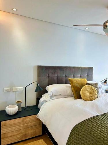 a bedroom with a large bed with a large headboard at Clifton Beach Apartment in Cape Town