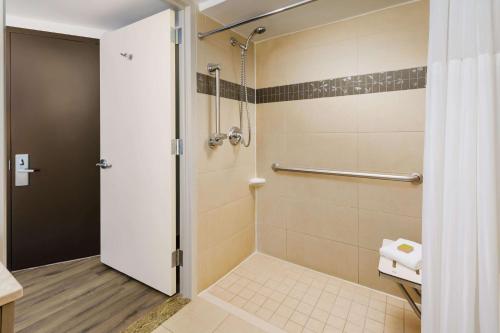 a bathroom with a shower with a glass door at DoubleTree by Hilton Hotel New York City - Chelsea in New York