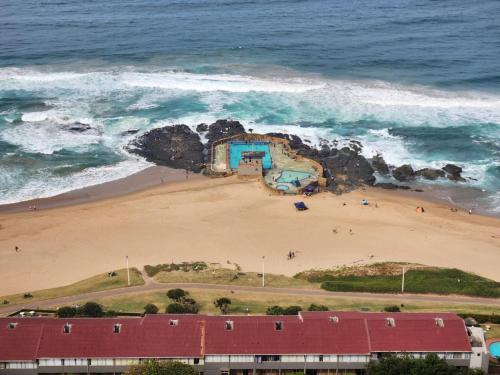 an aerial view of a beach with a building at Durban Holiday Apartments , 1901 on High Tide in Amanzimtoti
