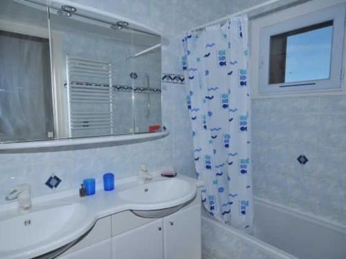 a white bathroom with a sink and a mirror at Appartement Huez, 3 pièces, 6 personnes - FR-1-405-1 in L'Alpe-d'Huez