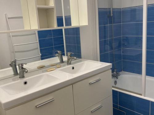 a bathroom with a white sink and a shower at Appartement Huez, 4 pièces, 8 personnes - FR-1-405-37 in L'Alpe-d'Huez