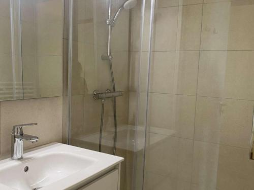a shower with a glass door next to a sink at Appartement Huez, 2 pièces, 4 personnes - FR-1-405-111 in L'Alpe-d'Huez
