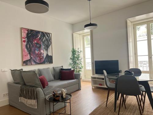 a living room with a couch and a table at Mouraria Best Apto in Lisbon