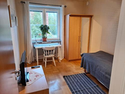 a bedroom with a bed and a desk with a computer at Karls ställe in Östersund