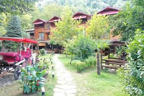 a resort with a horse drawn carriage in front of it at Gonul Sofrası Otel & Bungalow in Sapanca