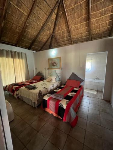 a bedroom with two beds in a room at Vanross Bushveld Self Catering Accommodation in Maraheki