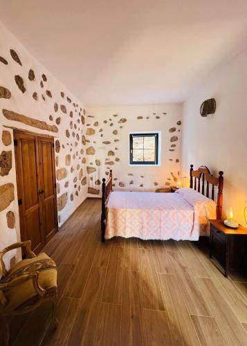 a bedroom with a bed and a wooden floor at Casa Abuela Inés in Puerto del Rosario