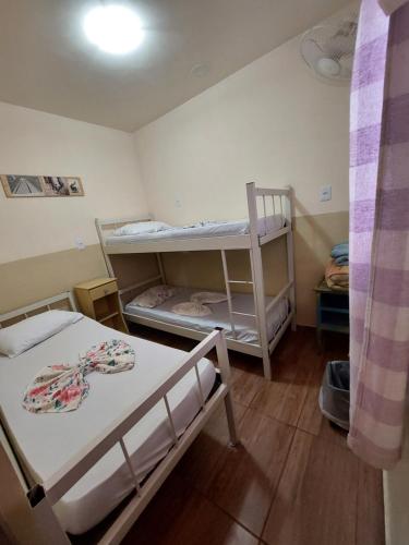 a small room with two bunk beds in it at Hostel BH in Belo Horizonte