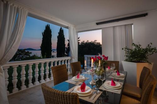 ein Esszimmer mit einem Tisch und einem großen Fenster in der Unterkunft Luxury Villa Bella Vista with Swimming Pool in Betina
