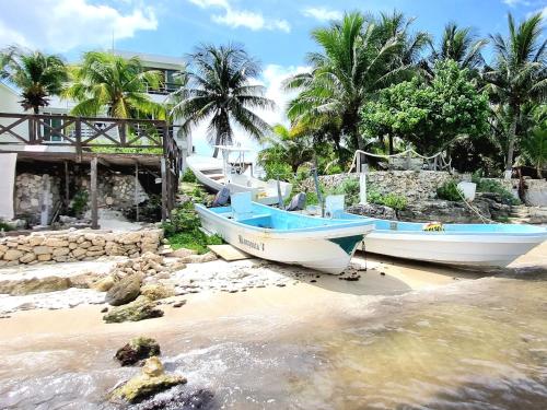 a group of boats sitting on the beach at On The Beach - Seaside Sunrise Haven 3 Bedrooms SEA VIEW in Cancún