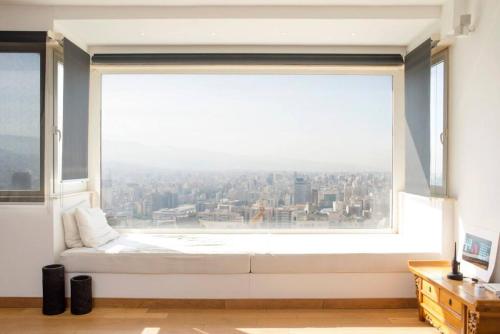 una camera da letto con una grande finestra con vista sulla città di Loft With a View 24 7 Electricity a Beirut