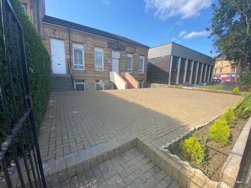 a brick walkway in front of a building at Rangers GuestHouse in Glasgow