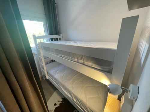 a bedroom with two bunk beds and a window at Immodelpas Tres estrelles in Pas de la Casa