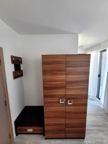 a large wooden cabinet in a room with a bed at Rainbow 3 Sunny Beach Topo Apartment in Sunny Beach