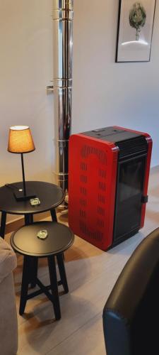 a tv sitting on the floor next to two tables at Apartamentos Rurales Argame in Argamé