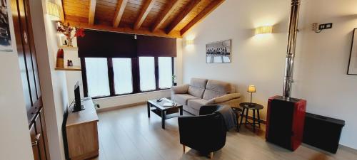 a living room with a couch and a chair at Apartamentos Rurales Argame in Argamé