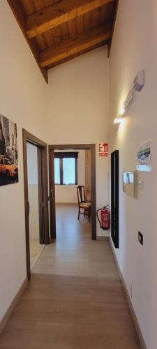 a room with a hallway with a table and a chair at Apartamentos Rurales Argame in Argamé