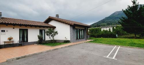 a house with a parking lot in front of it at Apartamentos Rurales Argame in Argamé