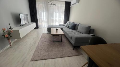 a living room with a couch and a table at Soflu apartments Plovdiv in Plovdiv