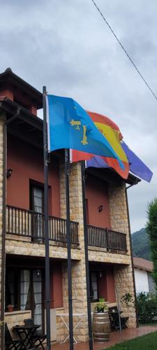 a colorful umbrella in front of a building at Apartamentos Rurales Argame in Argamé