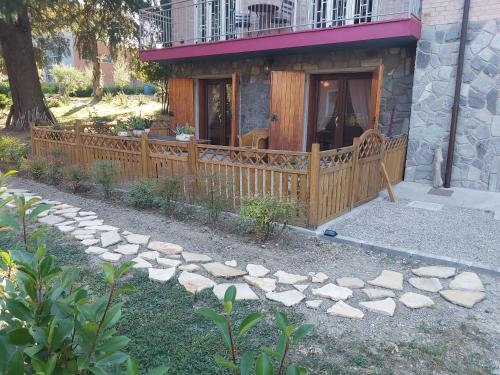 a wooden fence in front of a house at B&B Borgo dei Cedri in Pontecchio