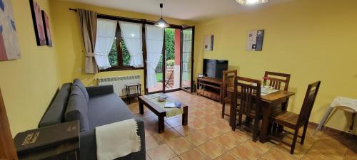 a living room with a couch and a table at Apartamentos Rurales Argame in Argamé