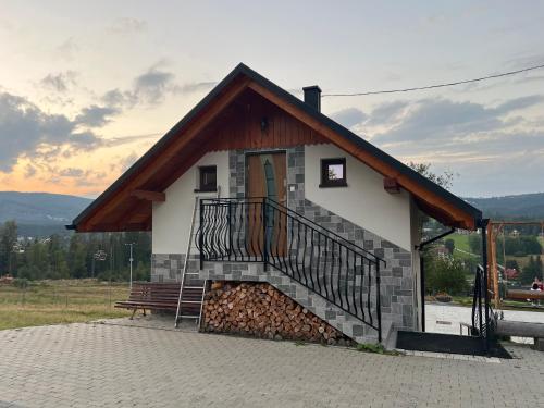 a small building with a staircase and a bench at Na Stoku in Istebna