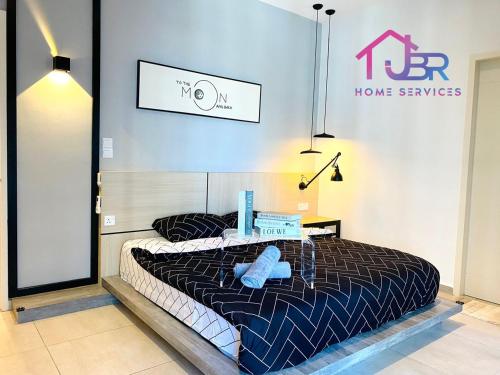 a bedroom with a bed with a laptop on it at JBR LUXURY HOMESTAY-ATLANTIS RESIDENCES-Near Jonker Walk-City Area-Netflix in Melaka