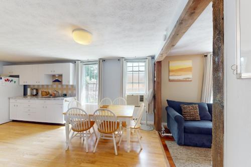 a kitchen and a living room with a table and chairs at Cabin at the Beach in Old Orchard Beach