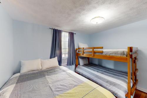 a bedroom with two bunk beds and a window at Cabin at the Beach in Old Orchard Beach