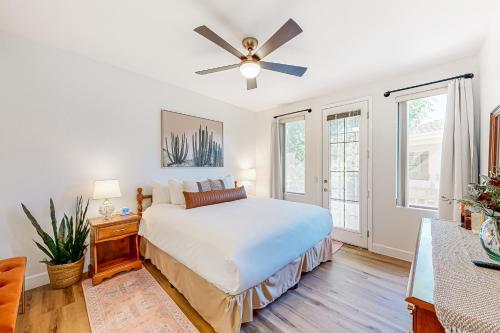 a white bedroom with a bed and a ceiling fan at Kierland Greens #2122 in Scottsdale