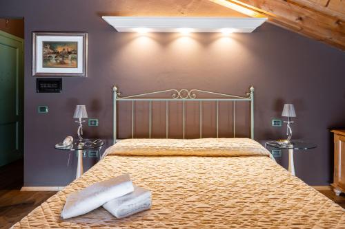 a bedroom with a large bed with two pillows on it at Residenza Villa Vecelli Cavriani in Mozzecane
