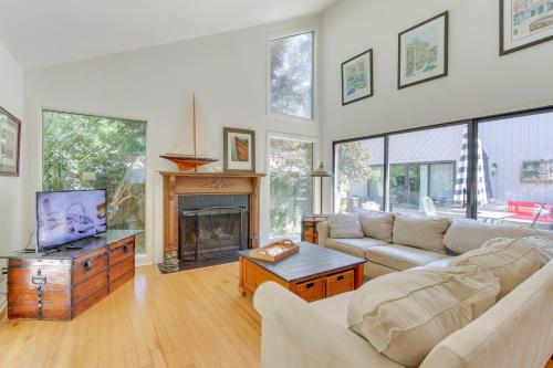 a living room with a couch and a fireplace at 2 Mi to Beach Hilton Head Home with Furnished Deck in Hilton Head Island