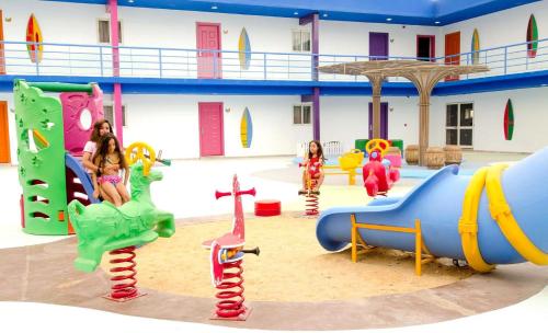 a group of children playing in a playground at Swiss Inn Teda Hotel & Aqua Park in Ain Sokhna