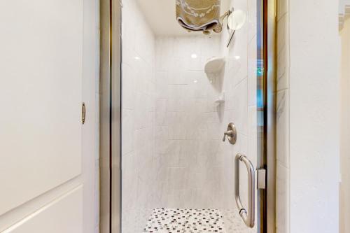 a shower with a glass door in a bathroom at Seabright in Santa Cruz