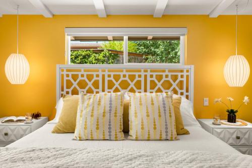 a bedroom with a white bed with yellow walls at DreamCatcher South Walk to Shop Dine Hike in Sedona