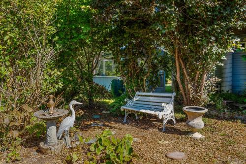a park bench and birds in a garden at Condra Cove in Copalis Beach