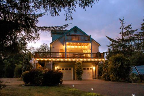 a house with a deck with lights on it at Condra Cove in Copalis Beach
